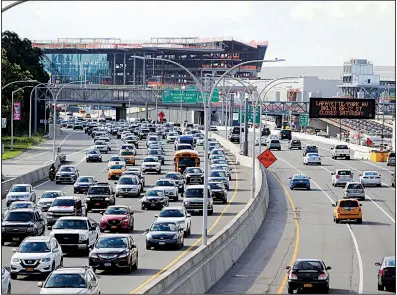  ?? AP/FRANK FRANKLIN II ?? Traffic passes LaGuardia Airport in New York on Wednesday. The Trump administra­tion contends that, by promoting the manufactur­e and sale of lighter cars, the President Barack Obama era standards could lead to 12,700 more auto fatalities.