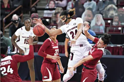  ?? AP Photo/Sean Rayford ?? South Carolina guard LeLe Grissett (24) drives to the hoop against Arkansas guard Amber Ramirez, right, during the first half of an NCAA basketball game Monday in Columbia, S.C.