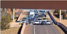  ??  ?? Emergency personnel block off the flyover from westbound Interstate 40 to southbound Interstate 25 following a fatal rollover crash Friday.