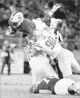  ?? Marcio Jose Sanchez Associated Press ?? S TA N F O R D running back Bryce Love leaps over UCLA defensive linemen Rick Wade and Boss Tagaloa. Love had 263 of Stanford’s 405 yards rushing in the game.