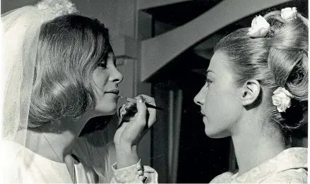  ??  ?? Anne-Marie de Spa applies makeup to her sister Genevieve for Genevieve’s wedding in 1967.