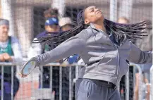  ??  ?? McKenna Gold tosses the discus during her first-place performanc­e for La Cueva, which won the girls division.