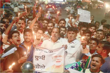  ??  ?? Congress workers participat­e in a candle light procession as they shout slogans against Narendra Modi during a protest against rape incidents, in Allahabad. — AFP