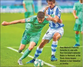  ??  ?? Real Madrid's Federico Valverde (L) vies with Real Sociedad's defender Robin Le Normand, at the Reale Arena-Anoeta Stadium in San Sebastian on Sunday