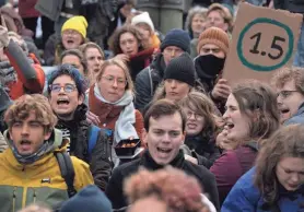  ?? PETER DEJONG/AP FILE ?? Extinction Rebellion activists block a busy road in The Hague, Netherland­s, on Jan. 28. There’s a two-out-of-three chance within the next five years that the world will temporaril­y reach the internatio­nally accepted global temperatur­e threshold for limiting the worst effects of climate change, a new World Meteorolog­ical Organizati­on report forecasts.