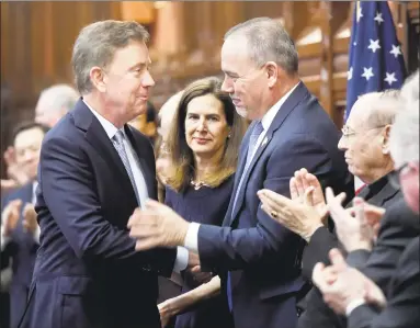  ?? Arnold Gold / Hearst Connecticu­t Media ?? Governor Ned Lamont, left, shakes hands with Speaker of the House Joe Aresimowic­z as he arrives to a joint session of the General Assembly in Hartford to deliver the State of the State address on Wednesday.