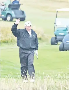  ??  ?? Trump gestures as he walks during a round of golf on the Ailsa course at Trump Turnberry southwest of Glasgow, Scotland, during the private part of his four-day UK visit. — AFP photo