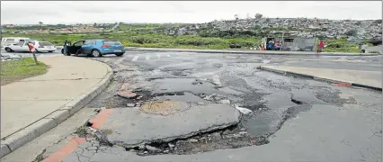  ??  ?? DANGEROUS HAZARD: A once tarred road in Duncan Village which has become virtually impassable for vehicles through long-term municipal neglect