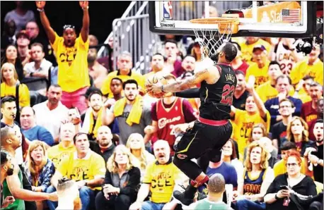  ?? AFP ?? LeBron James of the Cleveland Cavaliers goes up for a slam dunk in Game 3 of the 2018 NBA Eastern Conference finals against the Boston Celtics at Quicken Loans Arena on Saturday in Cleveland, Ohio.