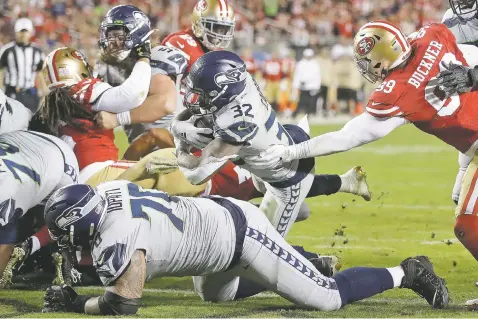  ?? BEN MARGOT/ASSOCIATED PRESS ?? Seahawks running back Chris Carson runs for a touchdown against the 49ers during the second half of Monday’s game in Santa Clara, Calif. Seattle beat San Francisco in overtime, 27-24. It was the 49ers’ first loss of the season.