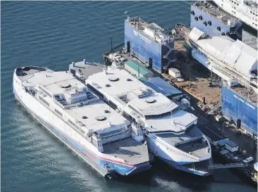  ??  ?? Two of the former B.C. Ferries Fast Cats sit tied up at the Washington Marine Group shipyard. NDP Leader John Horgan says many people talk about them, but few remember the details of the controvers­y.