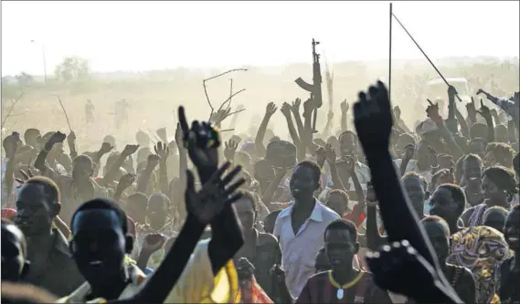  ?? Photos: Ivan Lieman/AFP and Jok Solomun/Reuters ?? Uncertaint­y: Sudan People’s Liberation Army soldiers and displaced citizens gather outside the UN Mission. South Sudan’s President Salva Kiir (below right) fired SPLA chief Paul Malong (below left), who fled and may be gathering his forces.