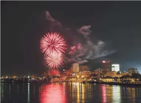  ?? THE COMMERCIAL APPEAL ?? Fireworks, as seen from Big River Crossing, erupt in front of the Downtown Memphis skyline for the 2018 Independen­ce Day Fireworks Spectacula­r.