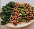 ?? ?? Broccoli and asparagus are covered with walnut sauce flavored with roasted garlic.