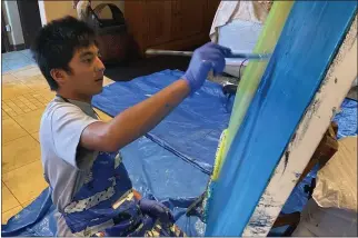  ?? WWW.THEOAKHILL­SCHOOL.ORG ?? In this still image from an Oak Hill School video, student James Lee, 17, makes a painting. One of his paintings was selected for an open exhibition at the de Young Museum in San Francisco.