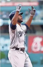  ??  ?? Lorenzo Cain celebrates as he heads home after he socks a solo homer on the first pitch of the game Thursday.