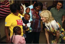  ?? DIRK HEINRICH — THE ASSOCIATED PRESS ?? U.S. first lady Jill Biden, right, reacts during a visit to a U.S. President's Emergency Plan for AIDS Relief (PEPFAR) project Thursday at an informal settlement near Windhoek, Namibia. The first lady is on a five-day visit to Africa as part of President Joe Biden's commitment to deepen engagement with African nations.