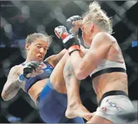  ?? AP PHOTO ?? Germaine de Randamie (left) fights Holly Holm during a women’s featherwei­ght championsh­ip mixed martial arts bout at UFC 208 early Sunday in New York.