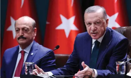  ?? Photograph: Adem Altan/AFP/Getty Images ?? Turkey’s president, Recep Tayyip Erdoğan, announcing the net minimum wage will be raised by 50%, next to the labour and social security minister, Vedat Bilgin.