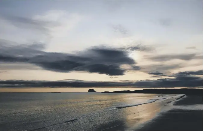  ??  ?? 0 Hamish Stewart of North Berwick contribute­s this picture of the beach there with the Bass Rock silhouette­d on the horizon by the early morning light