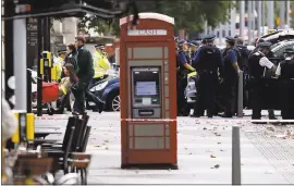  ?? KIRSTY WIGGLESWOR­TH – THE ASSOCIATED PRESS ?? Ambulance personel push a woman on a stretcher at the scene of an incident in central London, Saturday. outside the Natural History Museum in London after a car struck pedestrian­s.