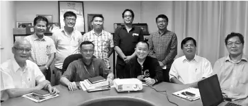  ??  ?? Archbishop John Wong (seated second left) with Fr Fundes Motiung (third right), Datuk Stephen Sondoh (second right), and architect Dr Tan Jun Kwang (right) at the meeting on Nov 15 at his office in Penampang. Seated at far left is Datuk Joseph Leong,...