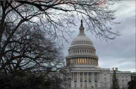  ?? J. SCOTT APPLEWHITE — THE ASSOCIATED PRESS ?? The Capitol is seen on the first morning of a partial government shutdown, as Democratic and Republican lawmakers are at a standoff with President Donald Trump on spending for his border wall, in Washington, Saturday. A partial federal shutdown took hold early Saturday after Democrats refused to meet President Donald Trump’s demands for $5 billion to start erecting a wall with Mexico.