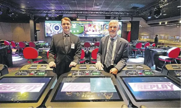  ?? LARRY WONG ?? Stephen Rowbotham, left, assistant general manager, and Kevin Booth, general manager, at the interactiv­e play stations in the renovated Starlight Casino at West Edmonton Mall, are preparing for the casino’s grand opening on Wednesday.