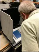  ?? PILOT NEWS GROUP PHOTO / JAMIE FLEURY ?? Marshall County Election Board member Rick Huff tests a voting machine.