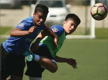  ?? DAVID BEBEE, RECORD STAFF ?? K-W United midfielder­s Isma Longo, left, and Ken Krolicki battle during a drill at practice on Wilfrid Laurier University’s alumni field Tuesday. Kitchener is in Pontiac, Mich., on Friday to face one of the top teams in the Premier Developmen­t League....