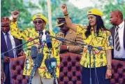  ?? Associated Press ?? Zimbabwe’s President Robert Mugabe, left, and his wife, Grace, chant the party’s slogan during a solidarity rally in Harare on Wednesday.