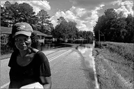  ?? MEG KINNARD/AP ?? Ivory Williamson, who checked on her home in Bucksport, S.C., said she didn’t “expect the water to bury us like this.”