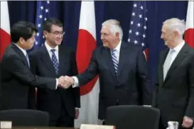  ?? THE ASSOCIATED PRESS ?? Japanese Defense Minister Itsunori Onodera, left, next to Japanese Foreign Minister Taro Kono, shakes hands with Secretary of State Rex Tillerson, next to Defense Secretary James Mattis, at the start of a Security Consultati­ve Committee meeting,...