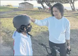  ?? HAVEN DALEY — THE ASSOCIATED PRESS ?? Keryn Francisco interacts with her 10-year-old son Reve Francisco on how to ride a bicycle in Alameda on Tuesday. As the U.S. economy rebounds from the ongoing pandemic, many women are choosing to sit out the labor force. During her time away from work, Francisco made a discovery that hadn’t quite seemed clear to her before: “I was burned out. I used to think that work-life balance was such a fantasy.” Now, she’s considerin­g the conditions for a full-time return to the workforce.