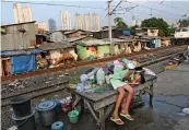  ??  ?? A file photo shows a young girl taking a break on a table at a slum near the main business district in Jakarta. —