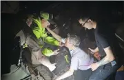  ?? LARRY MCCORMACK/THE TENNESSEAN VIA AP ?? Bill Wallace reaches out to rescue workers who freed him from his home that collapsed on him and his wife Shirley trapping them under rubble after a tornado hit Mt. Juliet, Tenn., on Tuesday, March 3.