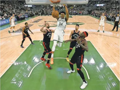  ?? JONATHAN DANIEL/GETTY IMAGES ?? Giannis Antetokoun­mpo led the Bucks with a 27.7 points per game regular-season average and is one of six Bucks who averaged double figures in points.