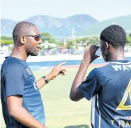  ?? PHOTOGRAPH­ER RUDOLPH BROWN/ ?? Jamaica College head coach Davion Ferguson gives instructio­ns to one of his players during a Manning Cup match last season.