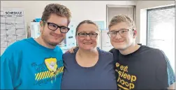  ?? THE COGNITIVE CLINIC ?? Zachary, left, and Austin Savickas pose for a snapshot recently with their mother. The brothers, who are legally blind and hearing impaired, recently made and delivered special messages for residents of Grace Point Place in Oak Lawn.