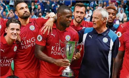  ?? — Reuters ?? Foxes wear red: leicester’s Wes Morgan holding the trophy as leicester celebrate after beating Celtic to win the Internatio­nal Champions Cup at Celtic Park on Saturday.