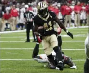  ?? BILL FEIG — THE ASSOCIATED PRESS ?? New Orleans Saints running back Alvin Kamara (41) carries for a touchdown past Tampa Bay Buccaneers defensive end Vinny Curry (97) Sunday.