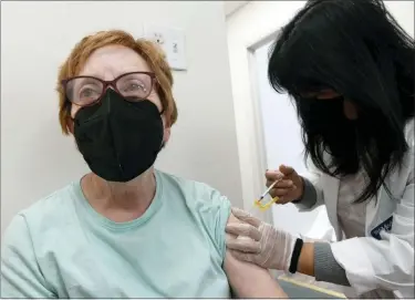  ?? BILL UHRICH — MEDIANEWS GROUP ?? Mary Kendig of Sinking Spring receives her second COVID-19booster shot Friday from pharmacist Amy Huynh at the Medicine Shoppe Pharmacy, 101W. Lancaster Ave., Shillingto­n. Fourth shots have recently been made available.