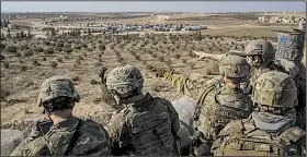  ?? The New York Times/MAURICIO LIMA ?? U.S. Special Forces soldiers watch from a front-line outpost near Manbij in northern Syria near the Turkish border in February. U.S. forces have been supporting Kurdish allies in Syria, and the decision to rapidly withdraw American units will leave Kurdish forces vulnerable to attack by Turkey.