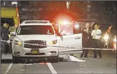  ?? Body of Pedro Almonte-Sanchez lies covered on Strong St. in Bronx, where he was getting into his SUV when a bike-riding gunman shot him in gang fight involving his 15-year-old son, who was in vehicle. ??