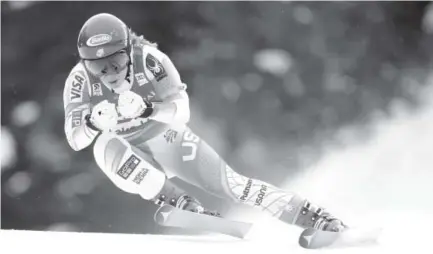  ??  ?? Colorado’s Mikaela Shiffrin goes into a tuck during the first women’s World Cup downhill of her career Friday at Lake Louise, Alberta. She finished 18th, nearly two seconds behind winner Ilka Stuhec of Slovenia. Jonathan Hayward, The Canadian Press