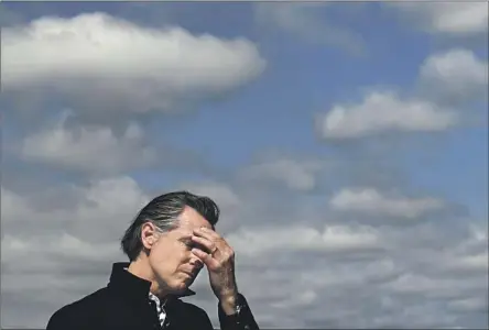  ?? Wally Skalij Los Angeles Times ?? GOV. GAVIN NEWSOM pauses as he stands next to a flooded strawberry field Wednesday in Pajaro, Calif. It’s only March, but Newsom has asked for — and received — not one, but two presidenti­al emergency declaratio­ns authorizin­g federal assistance for disaster response.