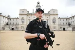  ??  ?? A police officer stands guard outside the Horse Guards Parade in London. Police arrested an 18-year-old man on Saturday in connection to their investigat­ion into Friday’s bombing on an Undergroun­d train. (AFP)