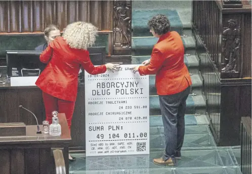  ?? ?? Minister Katarzyna Kotula, and MP Anna Maria Zukowska put up a mock abortion invoice in parliament alongside protesters, below