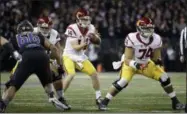  ?? ELAINE THOMPSON — THE ASSOCIATED PRESS FILE ?? In this file photo, Southern California quarterbac­k Sam Darnold takes a snap during the team’s NCAA college football game against Washington in Seattle. USC is in the No. 4 spot in The Associated Press’ preseason poll. Darnold, the Heisman Trophy...