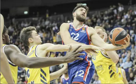  ??  ?? In this, Feb. 27, 2020, file photo, Vasilije Micic from Efes Istanbul, centre, jumps to the basket through the defense of Albas’ Jonas Mattisseck, left, and Luke Sikma, right, during their Euroleague
main round basketball match at the Mercedes-Benz Arena in Berlin, Germany. (AP)